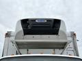 A 2018 Freightliner M2 106 truck with a large white refrigeration unit mounted on top of its cargo area