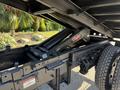 A 2017 Ford F-650 Super Duty truck with a visible hydraulic lift system under the bed and black frame components