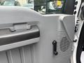 Interior door panel of a 2014 Ford F-550 featuring a handle speaker grille and window control mechanism