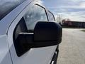 Close-up of the side mirror of a 2018 Ford F-150 in white color showcasing its sleek design and clean lines