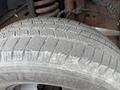 Close-up of a worn tire from a 2004 Ford F-350 SD showing tread patterns and visible signs of use