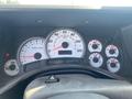 Dashboard of a 2003 Hummer H2 showing speedometer, tachometer, and odometer reading 33748 miles