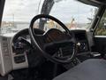 Interior view of a 2014 International 7500 truck showing the steering wheel and dashboard with controls and gauges