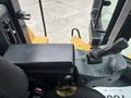 Close-up of the control panel and joystick inside a 2012 Caterpillar 980 heavy machinery operator's cabin