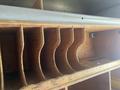 Wooden shelving unit with multiple compartments designed for storage inside a 2007 Morgan Olson Workhorse W42 vehicle
