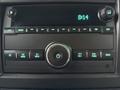 Dashboard display of a 2021 Chevrolet Express with an infotainment system featuring buttons for navigation radio and media controls along with a clock showing 8:14