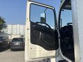 A 2012 Hino 338 truck with an open driver's side door displaying the interior and dashboard details