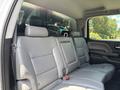 Interior of a 2020 Chevrolet Silverado showing gray leather rear seats with a spacious layout and seatbelts attached