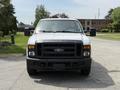 A white 2008 Ford F-250 Super Duty truck facing forward with a black grille and headlights