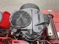 Close-up view of a 2017 Ferris Rotary engine featuring a large black air filter cover and exposed components with a textured tire in the background