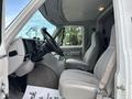 Interior view of a 1994 GMC Vandura 3500 showing the driver's seat and dashboard with a steering wheel and control panel