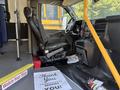 Interior view of a 2020 Chevrolet Express showing the driver's seat and dashboard with a thank you note on the floor