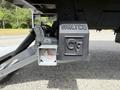 Close-up of a 2022 International MV607 truck chassis showing the WALTCO liftgate mechanism and hinge assembly