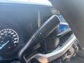 Close-up of the gear shift lever in a 2023 Ford F-350 SD showing controls for manual gear selection