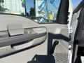 A close-up view of the interior door handle and controls of a 2004 Ford F-750 truck