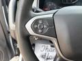 Close-up of the steering wheel of a 2017 Chevrolet Colorado featuring buttons for cruise control functions