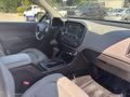 Interior view of a 2017 Chevrolet Colorado featuring a black dashboard gear shifter and center console with controls and touchscreen display