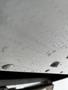 A close-up view of a white 2012 Workhorse W62 with droplets of water on its surface