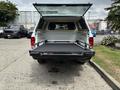 A 2013 RAM 1500 with its tailgate down and a truck bed liner visible inside the bed
