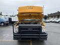 A 2021 Ford Econoline with its hood open showcasing the engine compartment