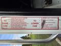 2010 Autocar Xpeditor with a safety instruction label for raising and lowering the cab including steps for operation and safety precautions