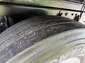 Close-up of a worn tire on a 2019 Ford F-750 showing visible tread wear and dirt on the surface