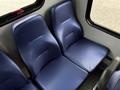 Two blue upholstered seats in a Chevrolet Express interior