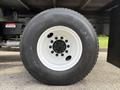 A close-up view of a white wheel and tire assembly from a 2011 International 4300 featuring a Toyo tire with visible tread patterns and a black lug nut pattern on the rim