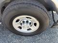 Close-up of a wheel on a 2017 Chevrolet Express featuring a silver rim and black tire tread