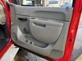 The image shows the interior door panel of a 2013 Chevrolet Silverado 3500HD featuring a gray design with controls and a cup holder area