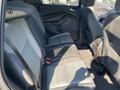 Interior view of a 2016 Ford Escape showing the backseat with two rows of seats in black and gray upholstery