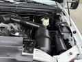 Engine compartment of a 2001 Ford F-350 showcasing various components including the air intake hose battery and fluid reservoir