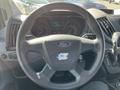 Steering wheel of a 2017 Ford Transit featuring the Ford logo with dashboard gauges visible in the background