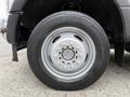 A close-up of a tire mounted on a silver wheel belonging to a 2020 Ford F-550 with a visible tread pattern and air valve