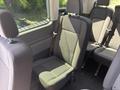 Interior seating of a 2025 Ford Transit T-350 featuring cloth upholstered seats in a gray tone arranged in a spacious layout