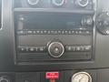 Dashboard of a 2018 Chevrolet Express featuring a digital clock and various audio and climate control buttons
