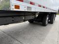 The image shows a 2019 Ford F-750 truck with a trailer attached featuring large black wheels and a robust undercarriage structure