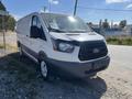 A 2017 Ford Transit van with a white exterior and black accents parked on a gravel surface