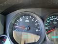 Close-up of the dashboard of a 2013 Chevrolet Silverado 1500 showing the RPM gauge and odometer reading 141993 km