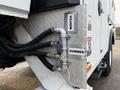 A close-up of a 2013 International Durastar 4300's mechanical panel showing winter and summer labeling with connected hoses and a valve assembly