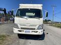A white 2014 Hino 195 truck facing forward with a boxy cargo area and large windshield