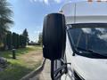 A 2018 Ford Transit-350 side mirror showing a black housing and part of the vehicle's white body