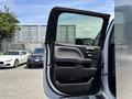 A 2020 Chevrolet Silverado truck door is open displaying the interior door handle and armrest design