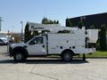 A white 2008 Ford F-550 bucket truck with an extended aerial lift in an upright position