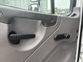 Interior door panel of a 2006 Freightliner M2 106 featuring a handle and a manual window crank