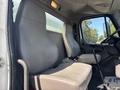 Two gray fabric seats inside a 2014 Freightliner M2 106 truck cabin with a gear shift and steering wheel visible