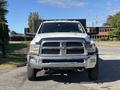 A 2014 RAM 5500 truck in white with a chrome grille and large front bumper facing directly towards the viewer