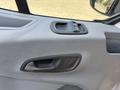 Interior door handle of a 2018 Ford Transit-350 with a sleek design and black plastic finish