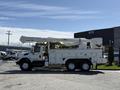 A white 2008 International 7500 truck with an extended aerial lift and storage compartments on the side