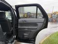 A 2019 Ford Explorer with an open front door showcasing the interior features and controls